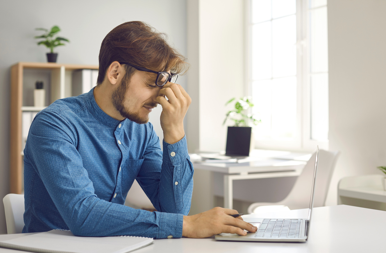 Stressed Tired Office Worker Has Eye Strain from Constant Work on Laptop Computer
